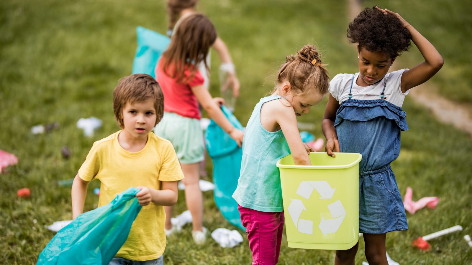 Kids sorting recyclables together outdoors