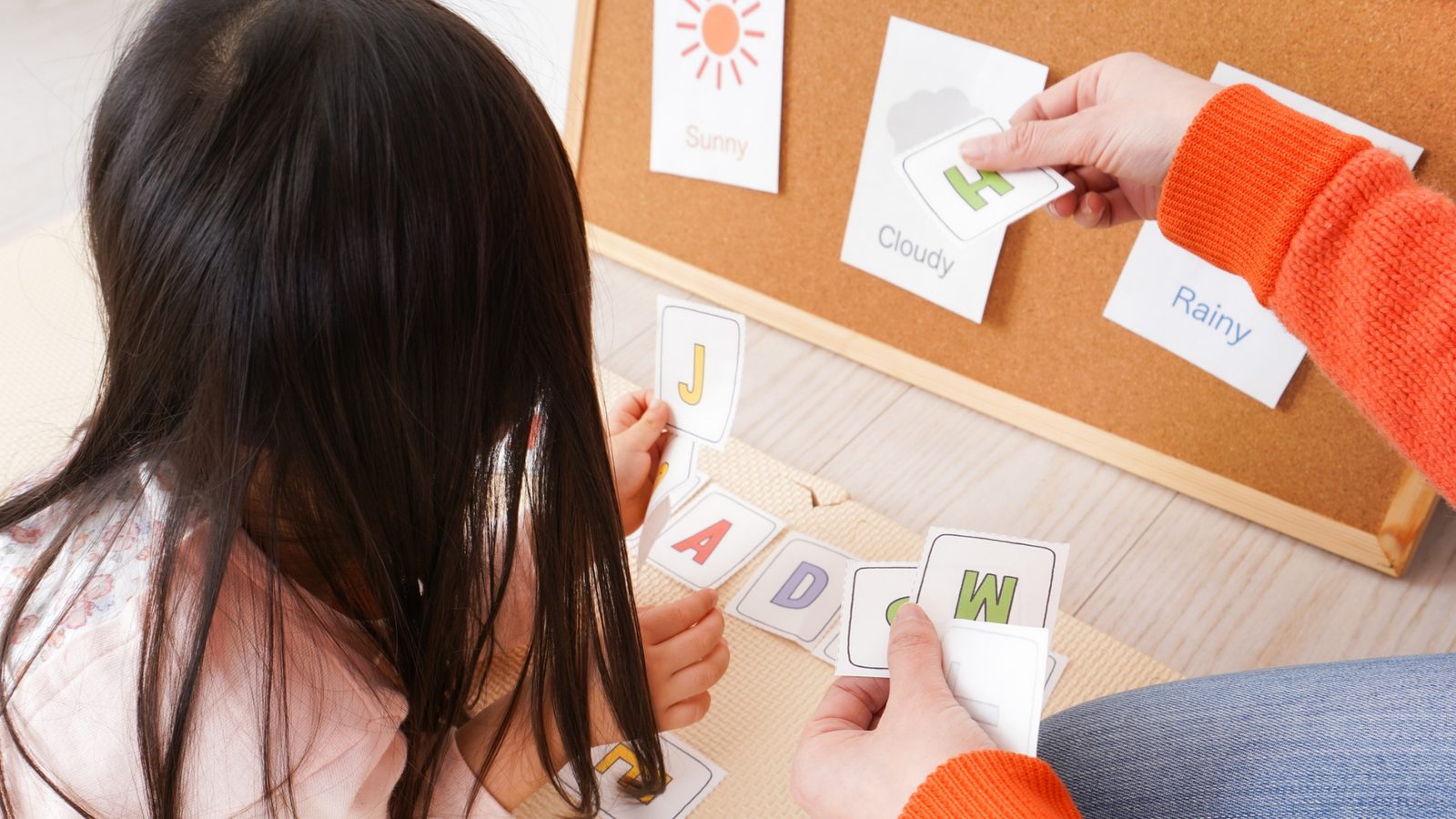 A kid learning new words with picture cards